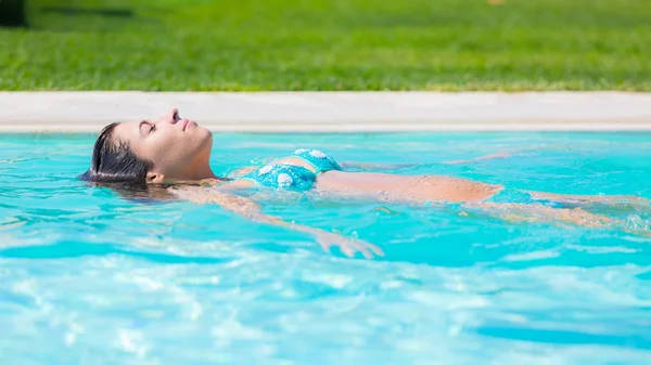 Bella giovane donna rilassante sulla superficie dell'acqua — Foto Stock