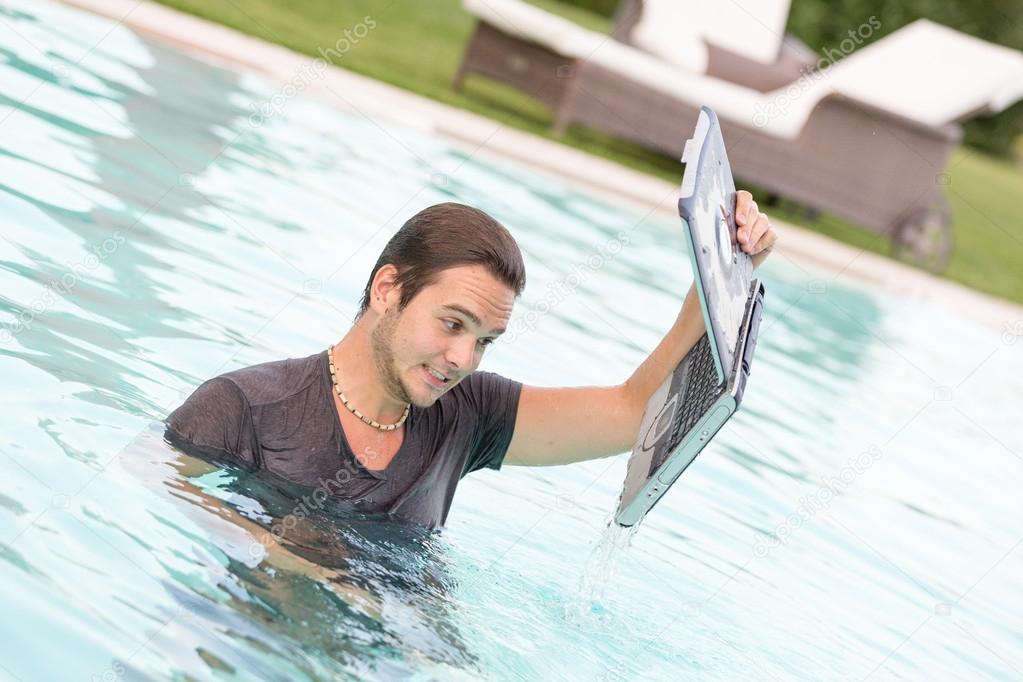 Man with Computer in the Swimming Pool