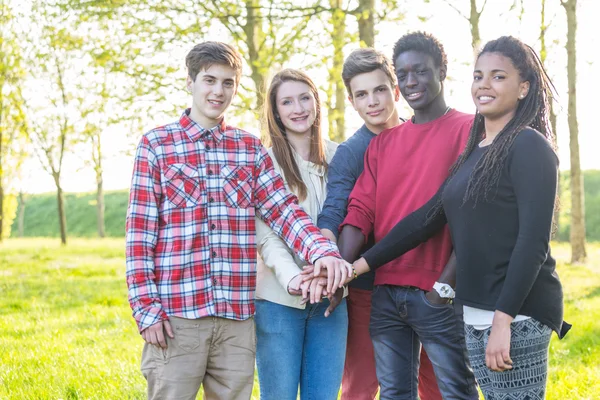 Teenagers with hands together — Stock Photo, Image