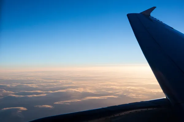 Clouds through airplane window — Stock Photo, Image