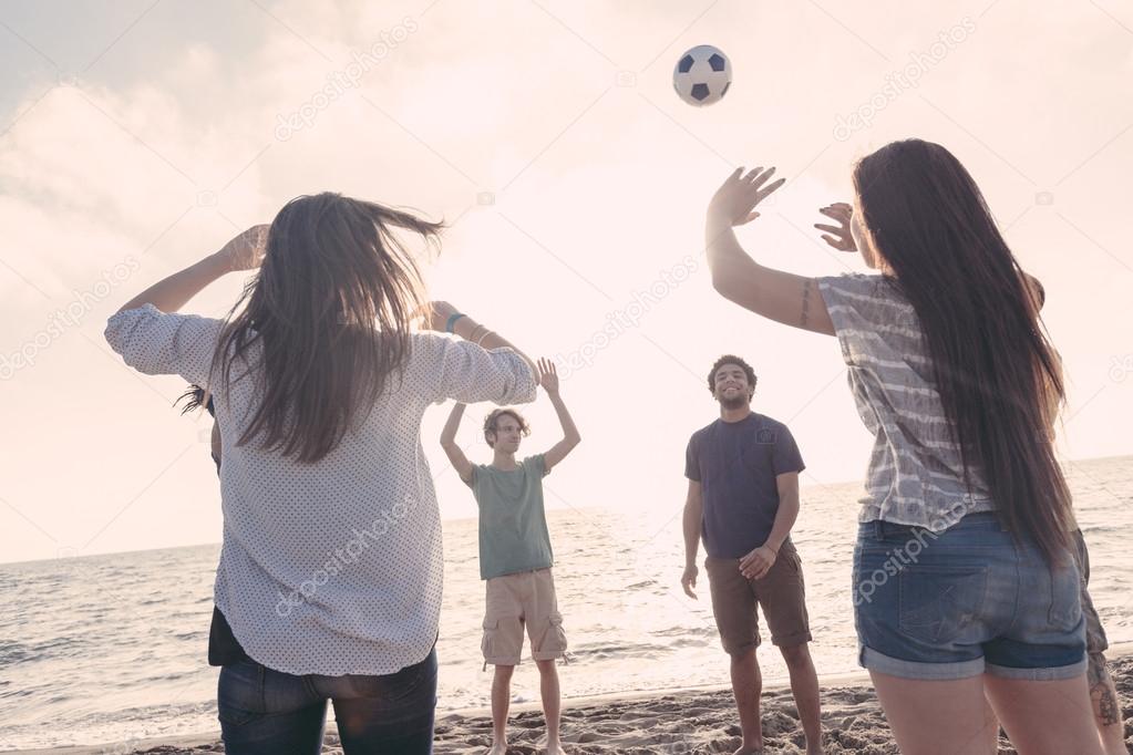 Multiracial Group of Friends Playing Volleyball at Beach