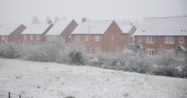 Chute de neige par une froide journée d'hiver en Angleterre dans un village typique — Video