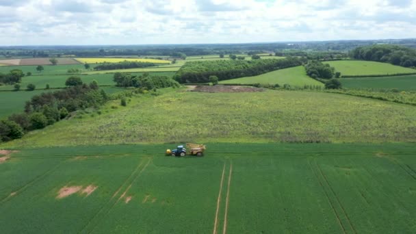 Aerial view of farming tractor crop sprayer in the countryside — Stock Video