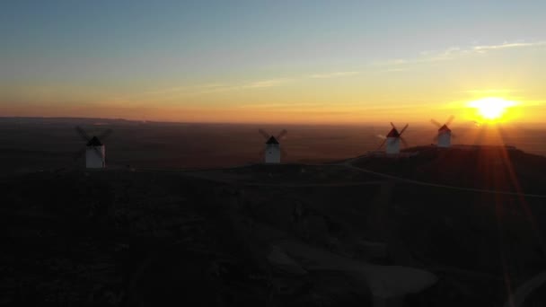 Aerial view of windmills in the countryside in Spain at sunrise — Stock Video