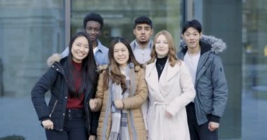 Group of mixed race college student friends portrait rejoicing and celebrating together, slow motion - Lifestyle, success and teamwork concepts with mixed race young millennial people