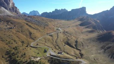 Mountain pass road aerial view with beautiful scenery on background in the Dolomites mountains in the Alps, Italy - Winding road, transport and travel concepts