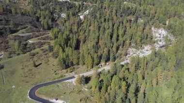 Mountain pass road aerial view with beautiful scenery on background in the Dolomites mountains in the Alps, Italy - Winding road, transport and travel concepts
