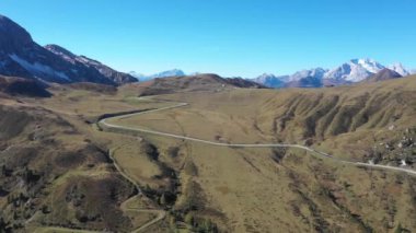Mountain pass road aerial view with beautiful scenery on background in the Dolomites mountains in the Alps, Italy - Winding road, transport and travel concepts