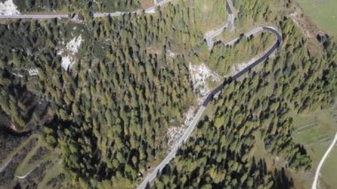 Mountain pass road aerial view with beautiful scenery on background in the Dolomites mountains in the Alps, Italy - Winding road, transport and travel concepts
