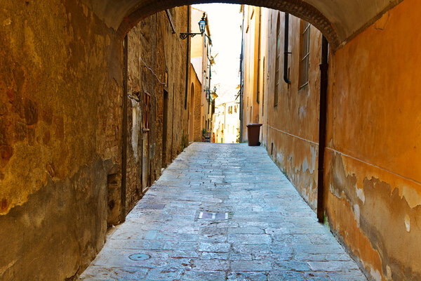 Narrow Alley with Old Buildings in Italian City of Volterra