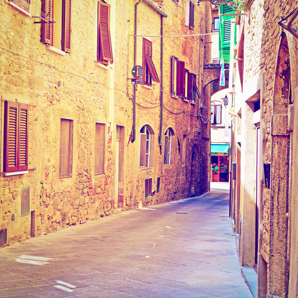 Narrow Alley with Old Buildings in Italian City of Volterra, Retro Effect