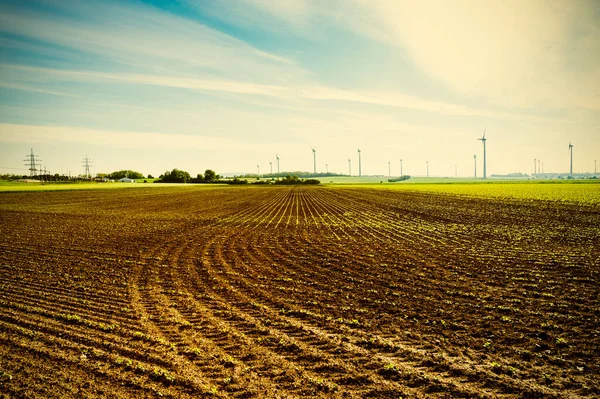 オーストリアの風景と近代的な風力タービンのエネルギー生産で耕した畑は ビンテージ スタイル — ストック写真