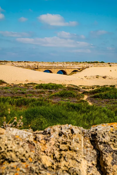 Ancient Roman aqueduct on the Mediterranean coast of Israel in the sand dunes