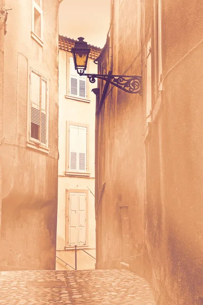 Narrow, deserted street in a French town during quarantine at dawn in a contemporary style.