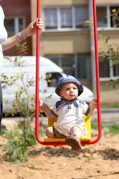 Baby swinging on swing — Stock Photo, Image