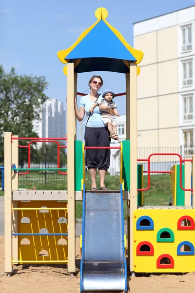 Mother with son on slide — Stock Photo, Image