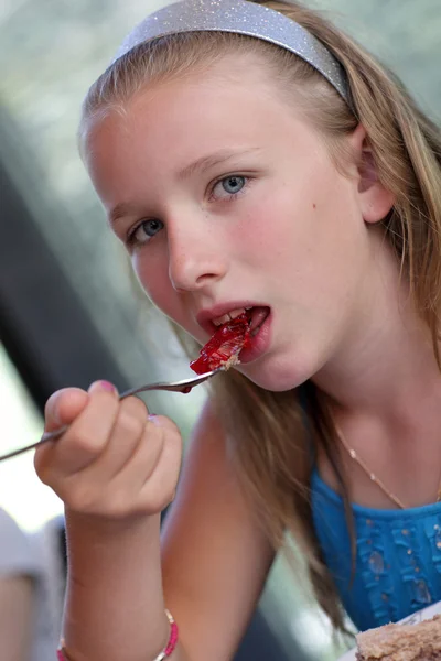 Girl eating jam — Stock Photo, Image