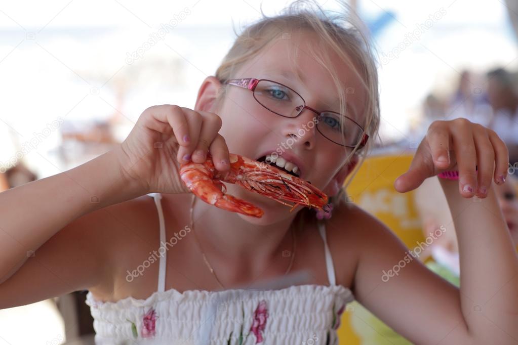 Girl biting shrimp