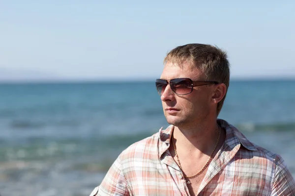 Portrait of man on sea background — Stock Photo, Image