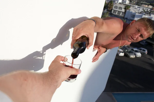 Pouring of wine on balcony — Stock Photo, Image