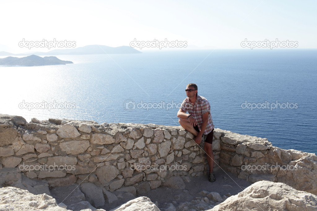 Man sitting on wall of castle