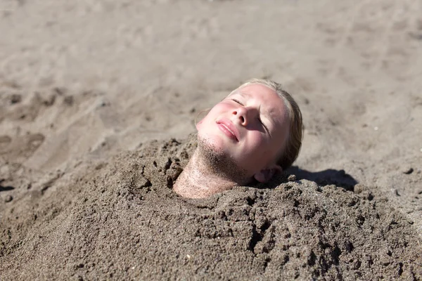 Girl buried in sand — Zdjęcie stockowe