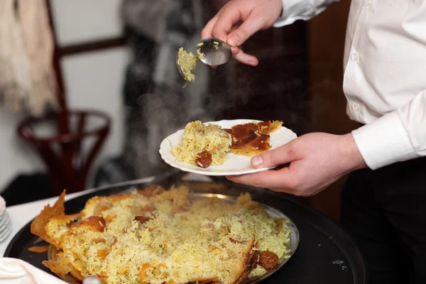 Chef putting pilaf — Stock Photo, Image