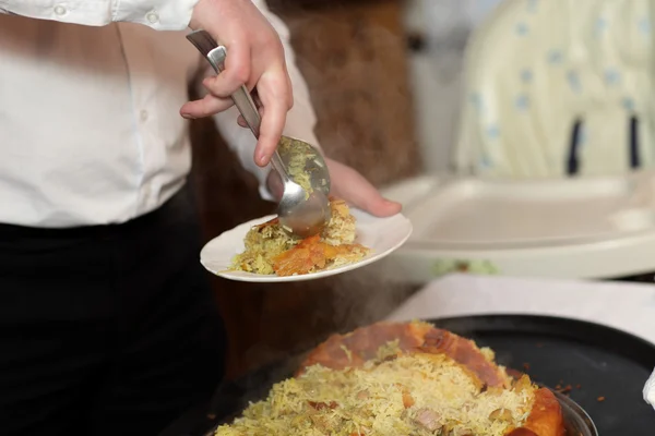 Cook putting pilaf — Stock Photo, Image