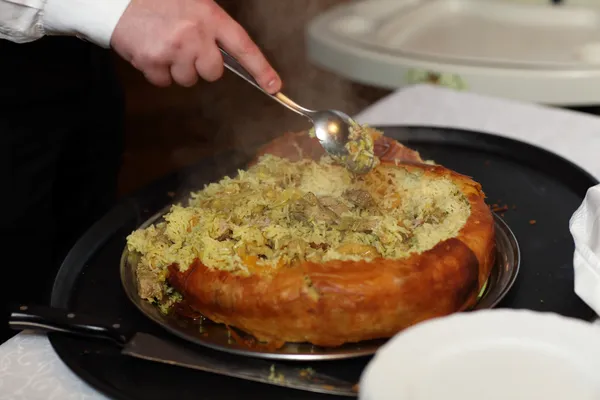 Waiter putting Khan Pilaf — Stock Photo, Image