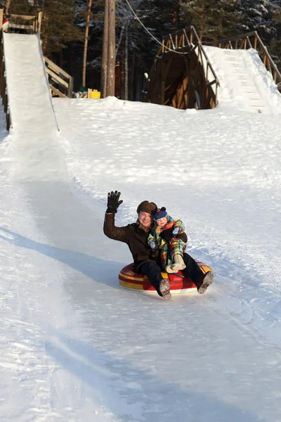 Excited family on a sled — Stock Photo, Image