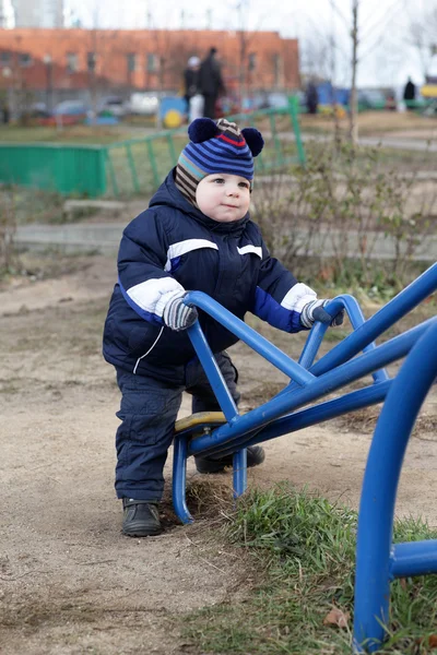 Toddler holding handle of seesaw — Stock Photo, Image