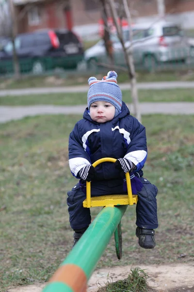 Pensive toddler on seesaw — Stock Photo, Image