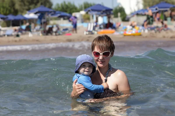 Мать держит младенца в море — стоковое фото