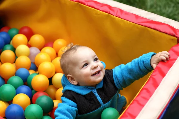 Toddler in box of balls — Stock Photo, Image