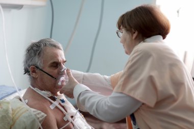 Nurse fixing oxygen mask clipart