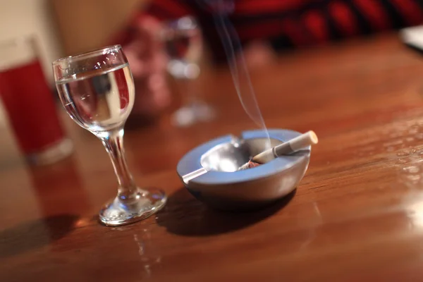 Cigarette and glass of vodka — Stock Photo, Image