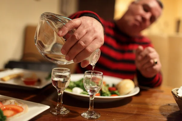 Man with decanter of vodka — Stock Photo, Image