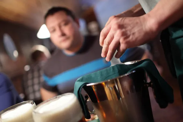 Waiter opens a bottle of vodka — Stock Photo, Image