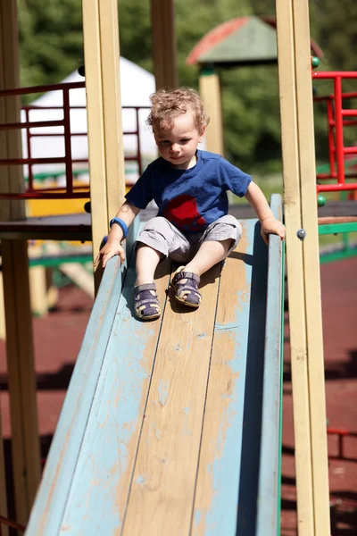 Toddler sliding on a slide — Stock Photo, Image