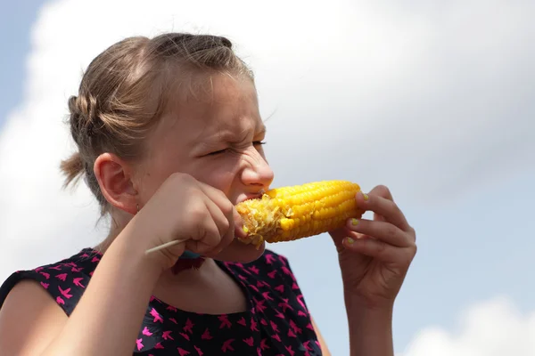Girl eating boiled corn — Stock Photo, Image