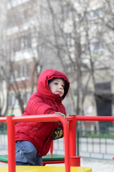 Child at playground in autumn — Stock Photo, Image