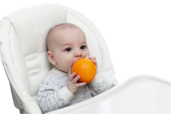 Baby biting orange — Stock Photo, Image