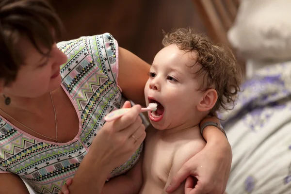 Мать чистит зубы своему ребенку — стоковое фото