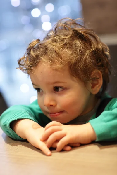 Pensive child at table — Stock Photo, Image