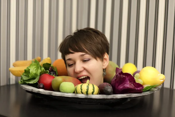 Женщина кусает фрукты — стоковое фото