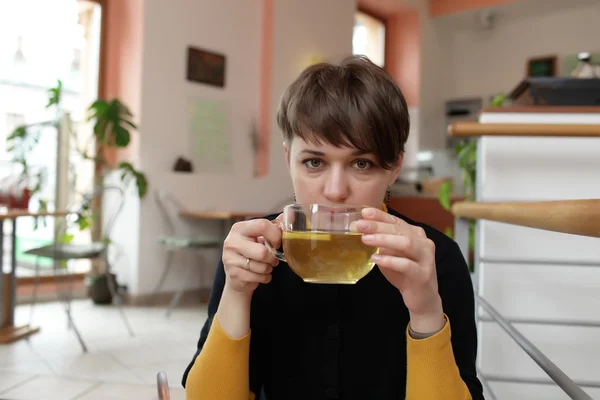 Woman with cup of green tea — Stock Photo, Image