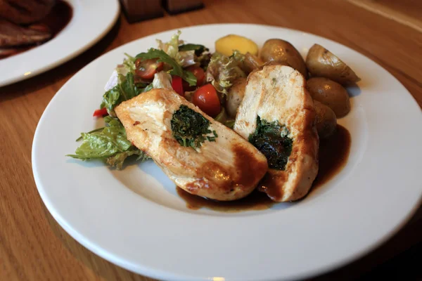 Chicken stuffed with fresh herbs — Stock Photo, Image