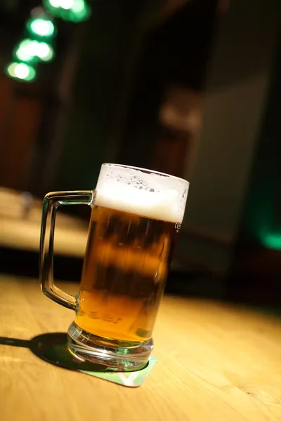 Glass of beer at pub — Stock Photo, Image