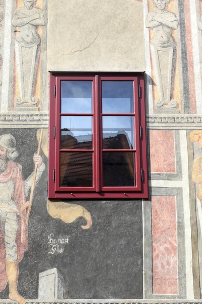 Painted wall with red window — Stock Photo, Image