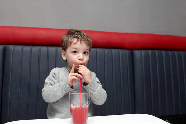 Child drinking fruit drink — Stock Photo, Image